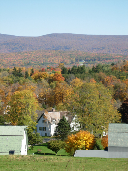 Taraden's main building with Fall foliage behind and mountains in the distance.